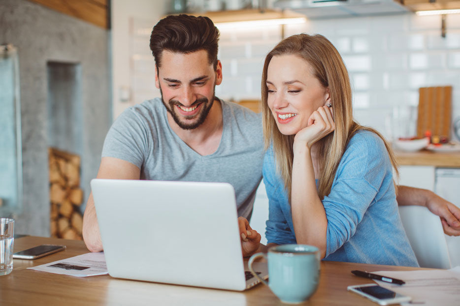 A couple looking at a laptop together