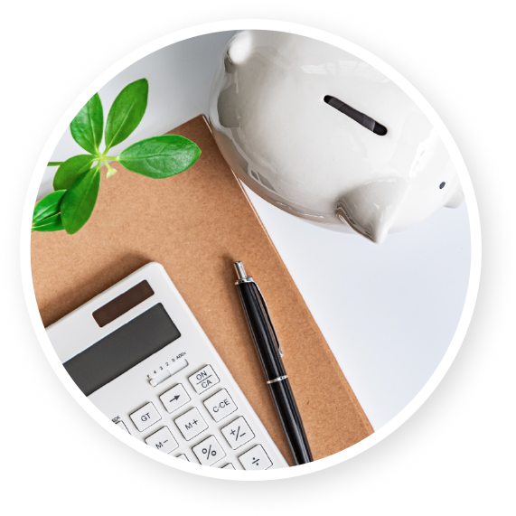 A piggy bank next to a calculator and a pen.