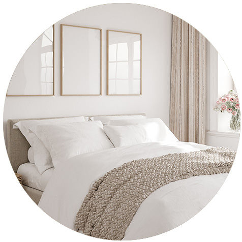 A white-painted bedroom with a clean, well-made bed.